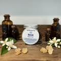 Neroli cream with frankincense and flowers and bottles on a wooden surface, to moisturise the skin